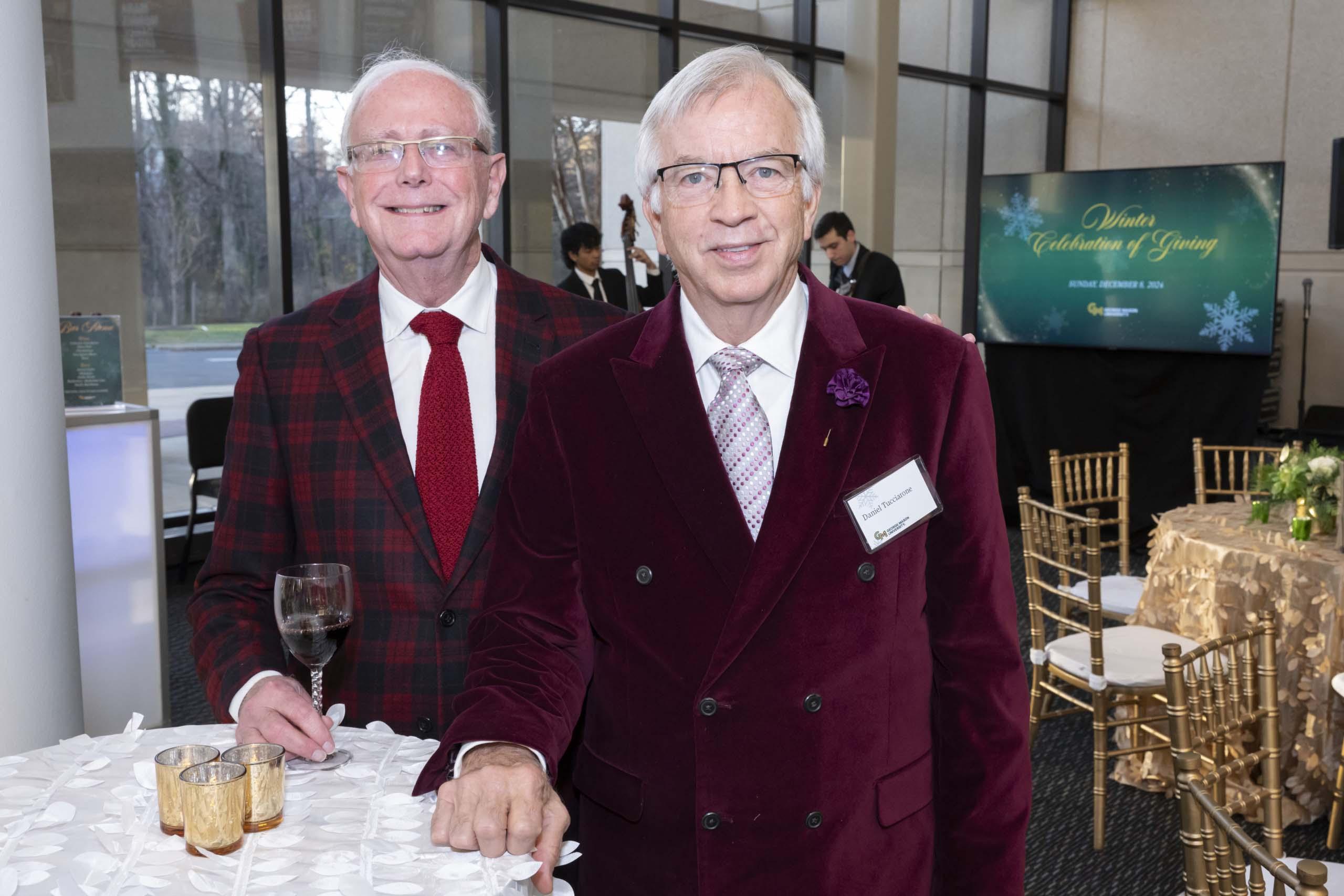Two 2024 Winter Celebration of Giving reception attendees.