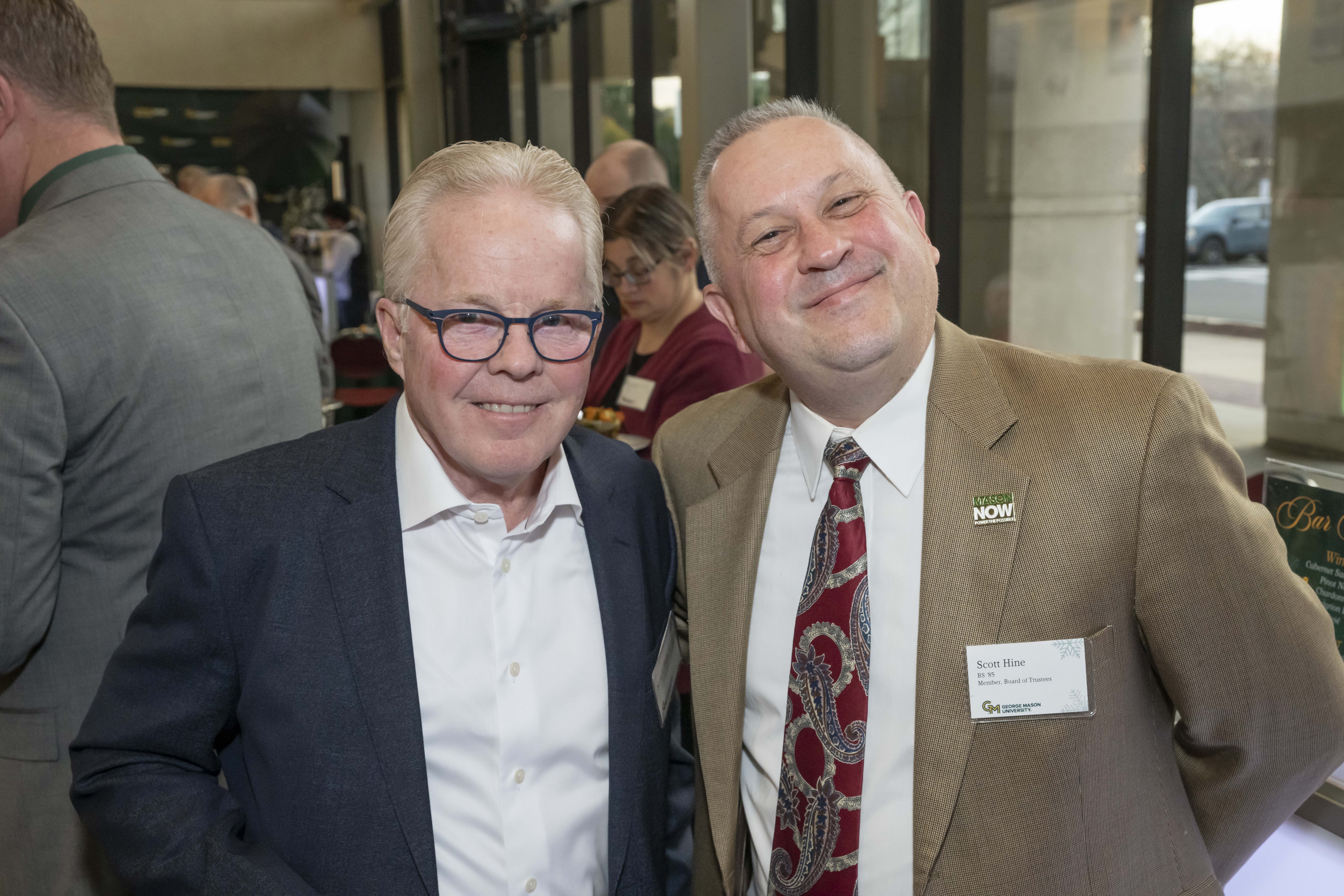 Two 2024 Winter Celebration of Giving reception attendees.