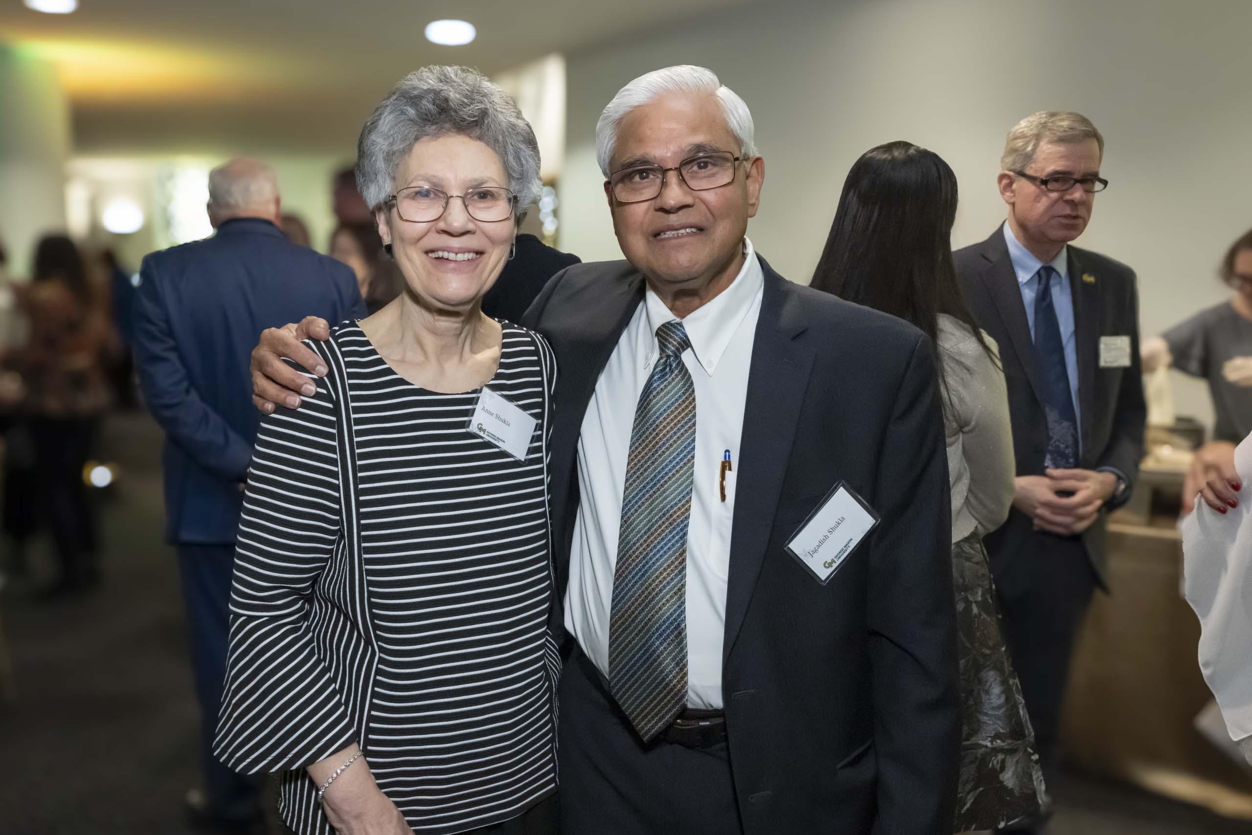 Two 2024 Winter Celebration of Giving reception attendees.