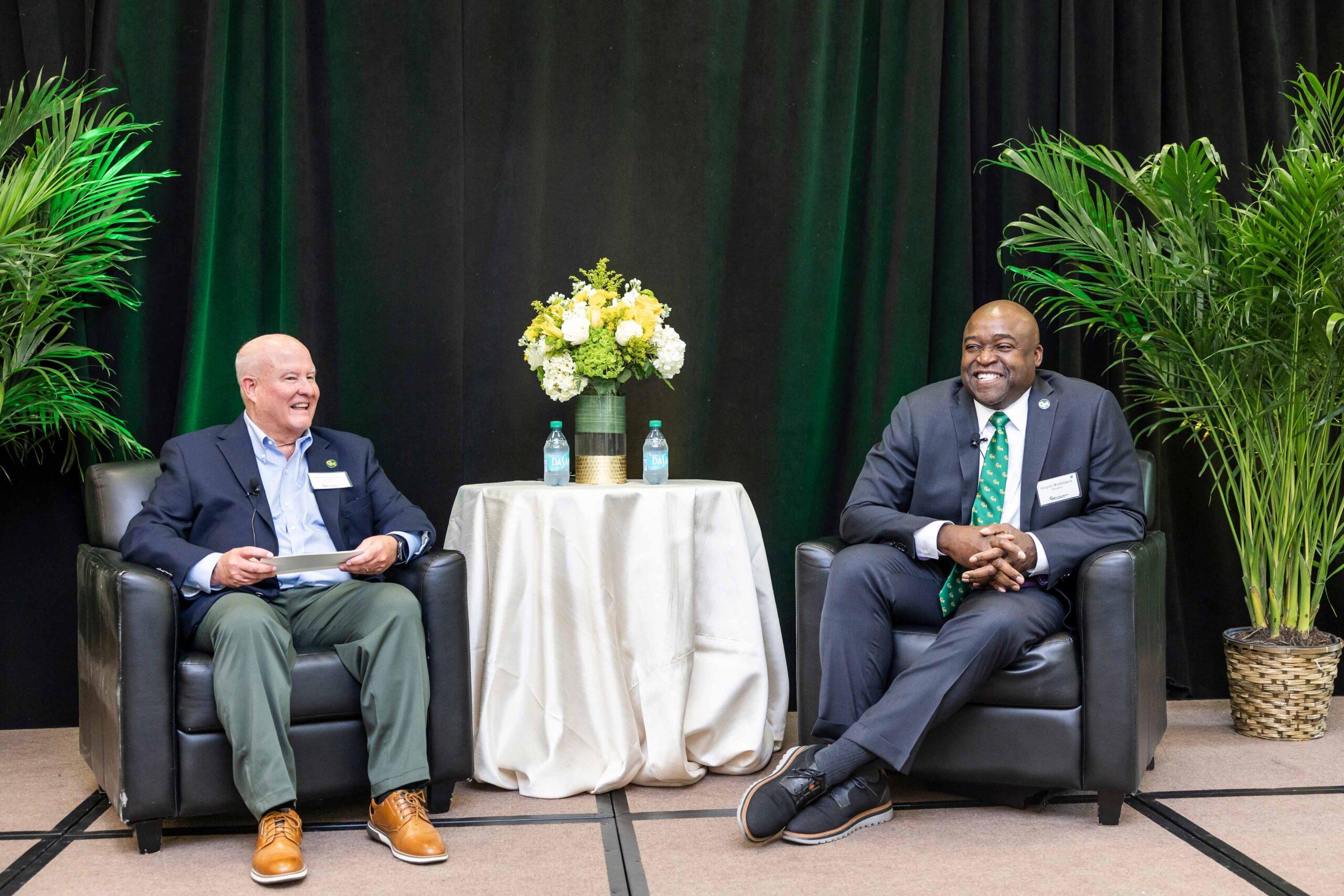Dr. Gregory Washington seated next to Brian Drummond on stage.