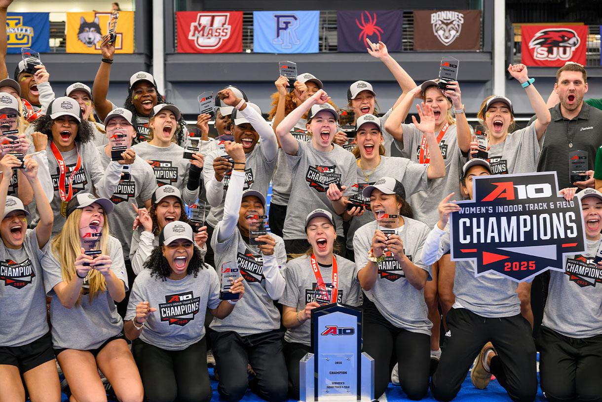 Cheering students wearing their champion shirts and holding a champion sign