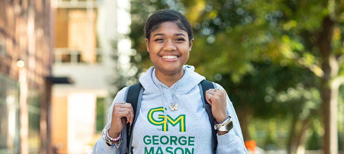 Smiling young student wearing a GMU sweatshirt