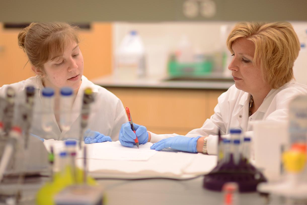 A faculty and student researchers working together in a lab