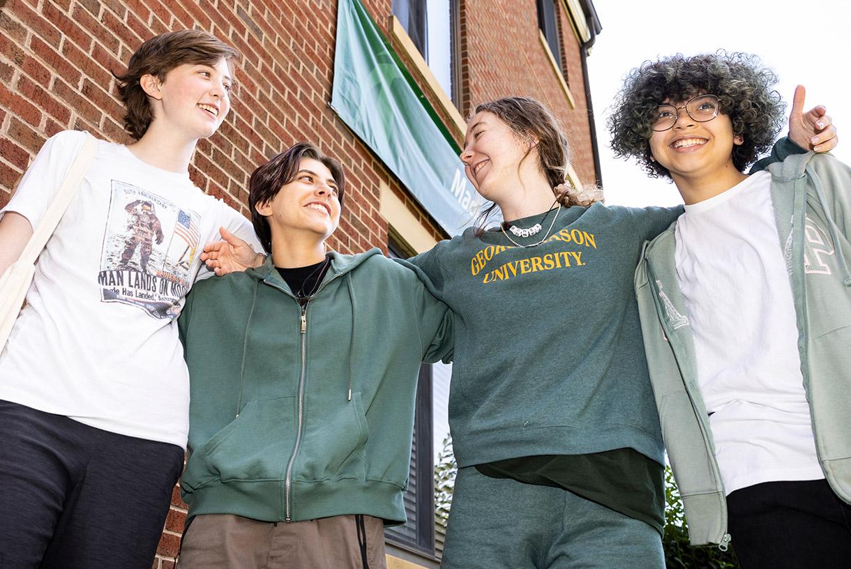 Four students standing together outside