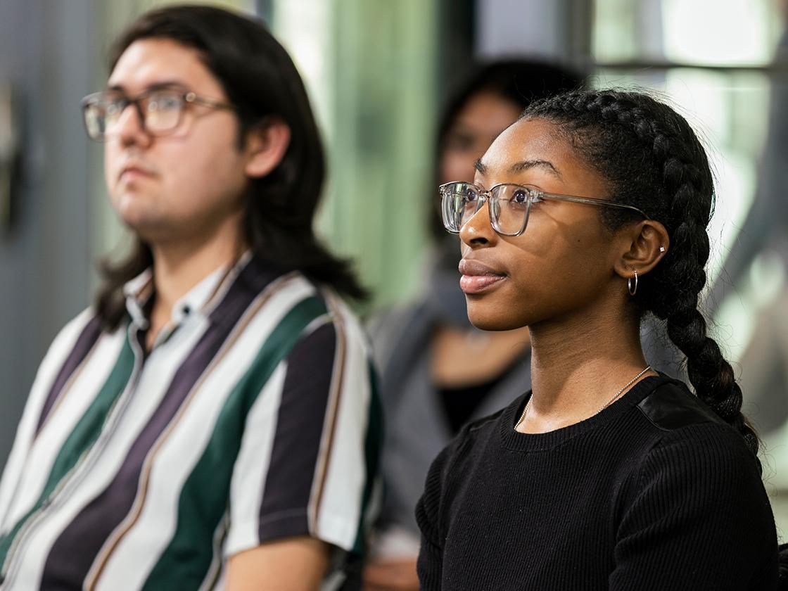 Young student listening to speaker