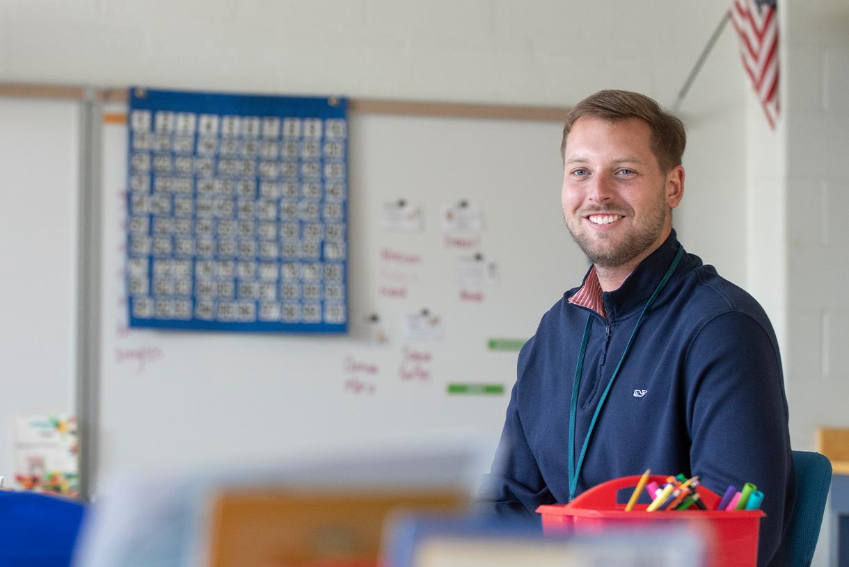 Young male teacher in classroom