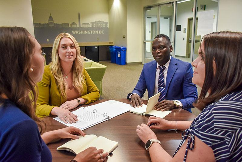 Staff sitting at a round table