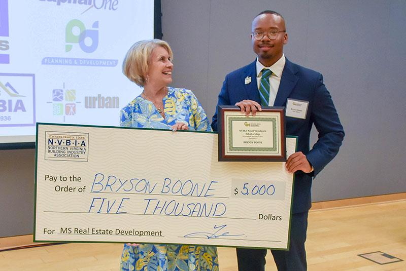 Donor with faculty holding a large check