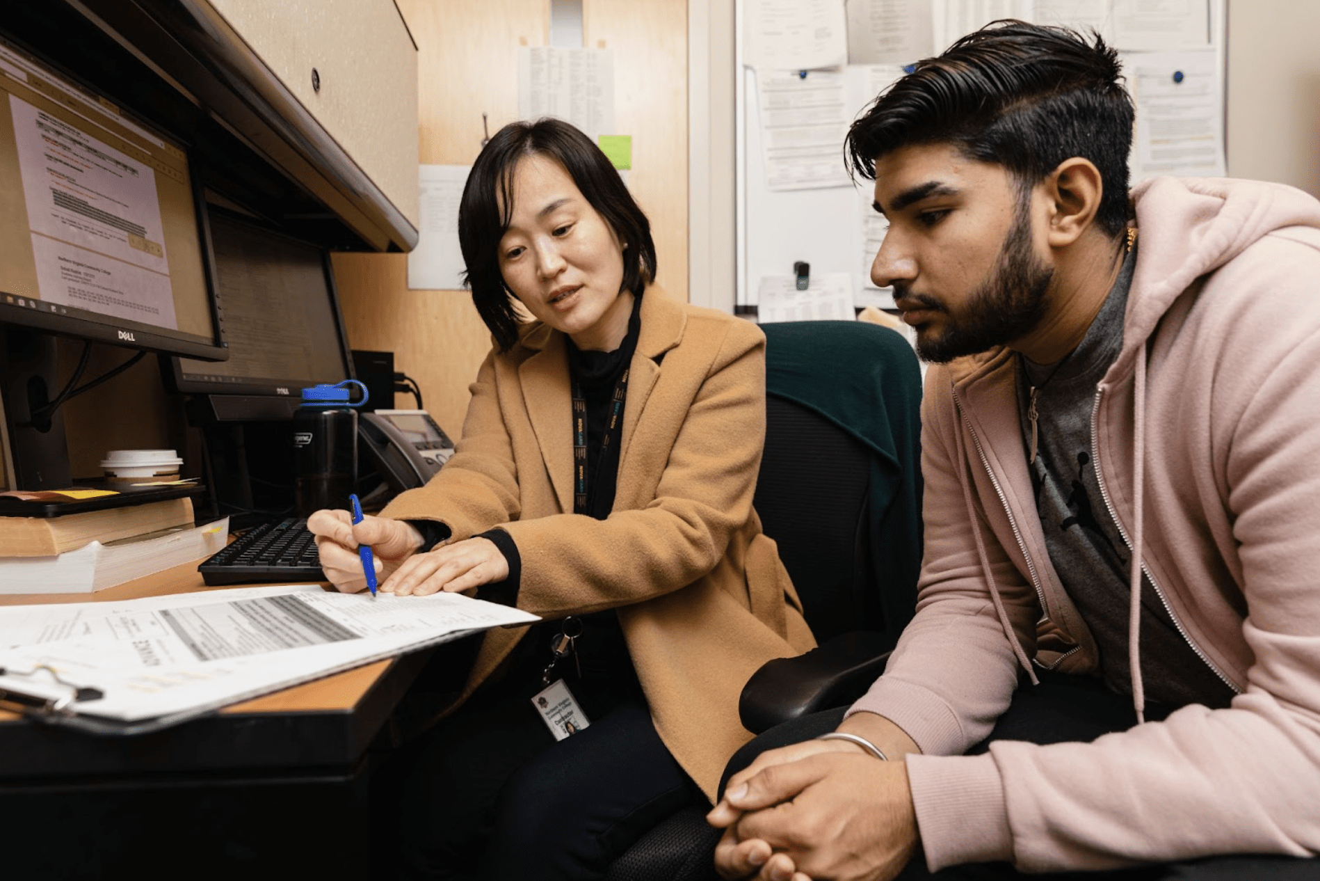 Professor working with a student at a desk