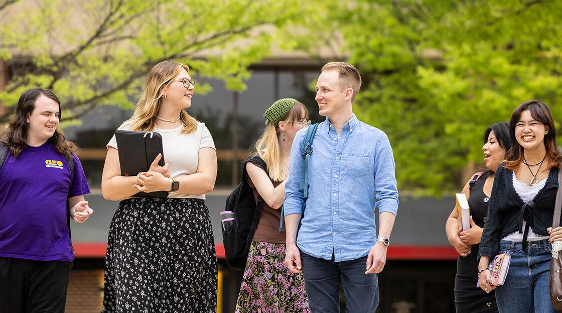 Smiling students walking together outside