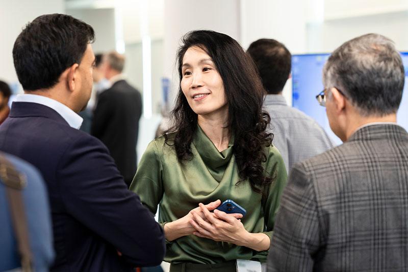Woman smiling while chatting with others