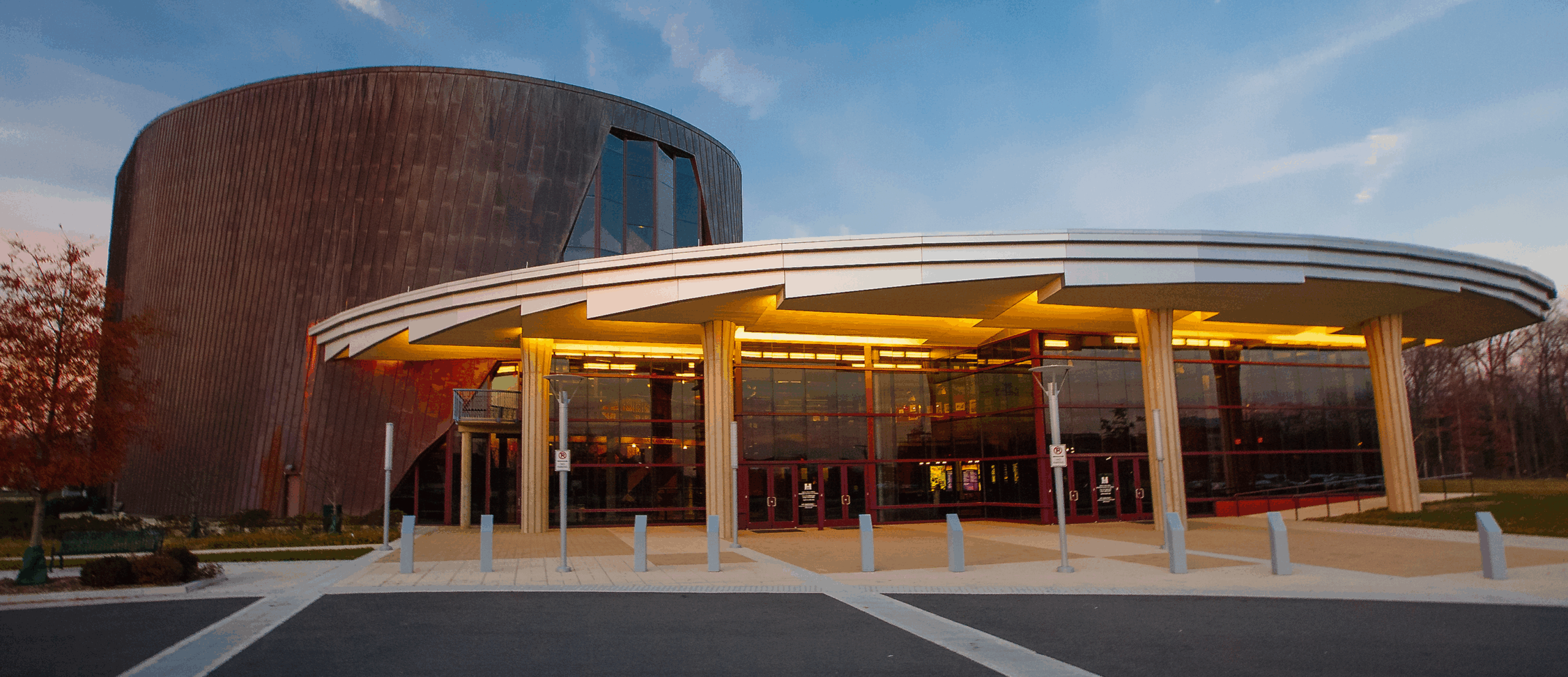 Facade of a round theatre building during twilight