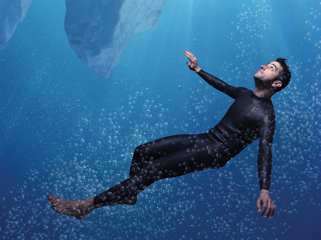 Digital mock up of man in a black suit under water