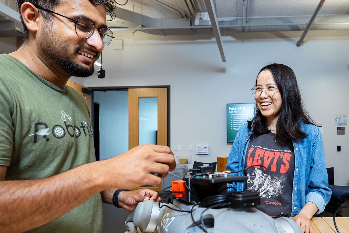Two students working on a robot