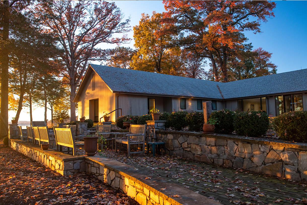 A brick building by the lake during sunset