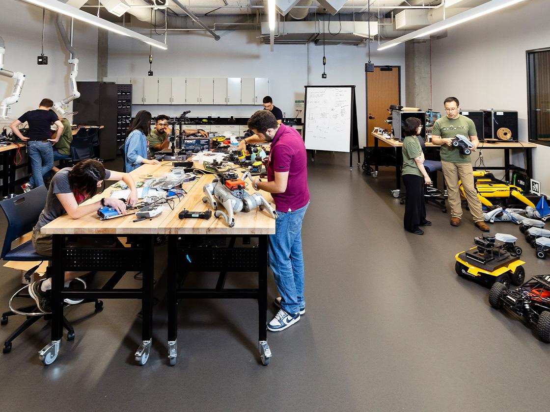 Students working in a large robotics lab