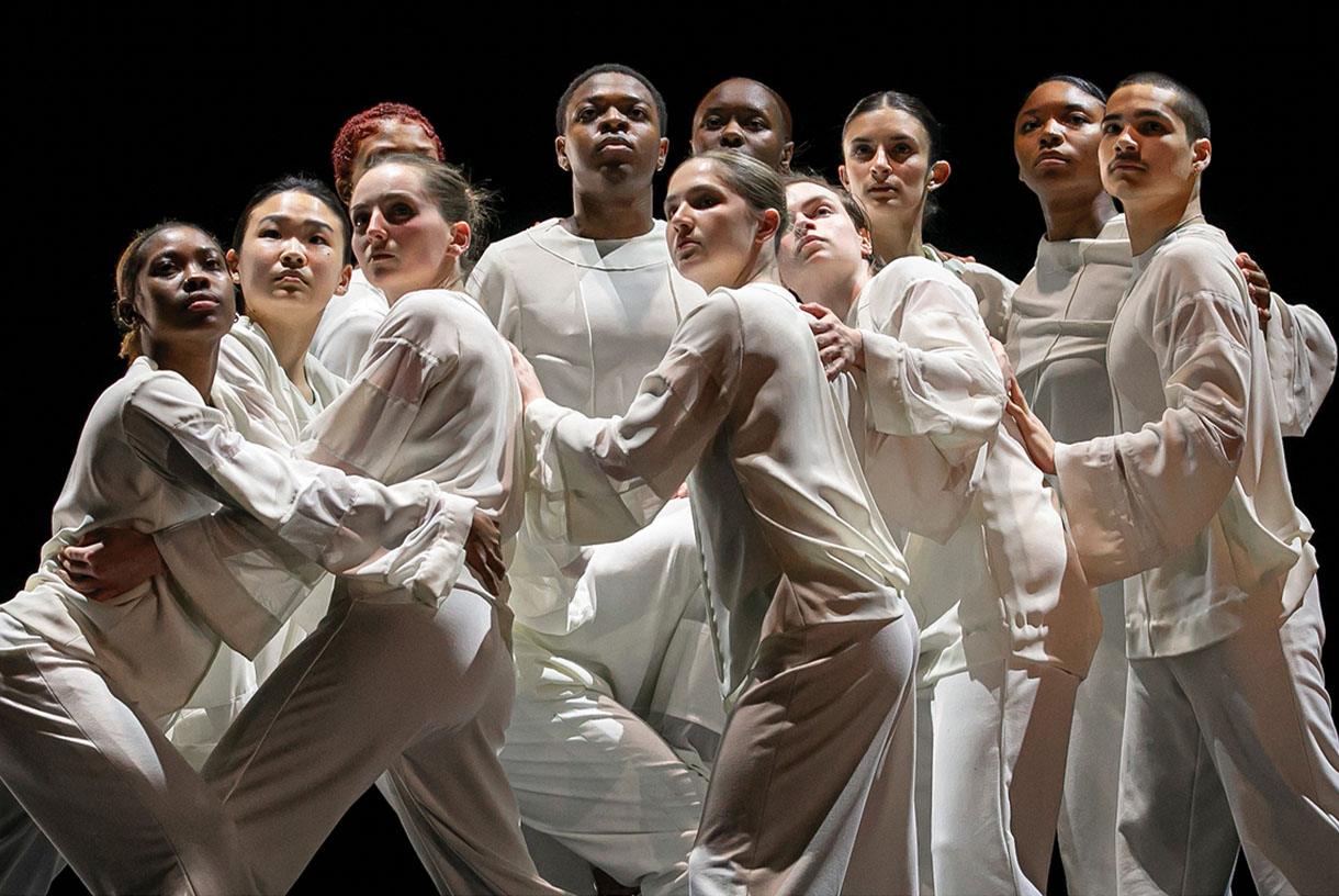 Dance students during a performance and wearing matching white outfits
