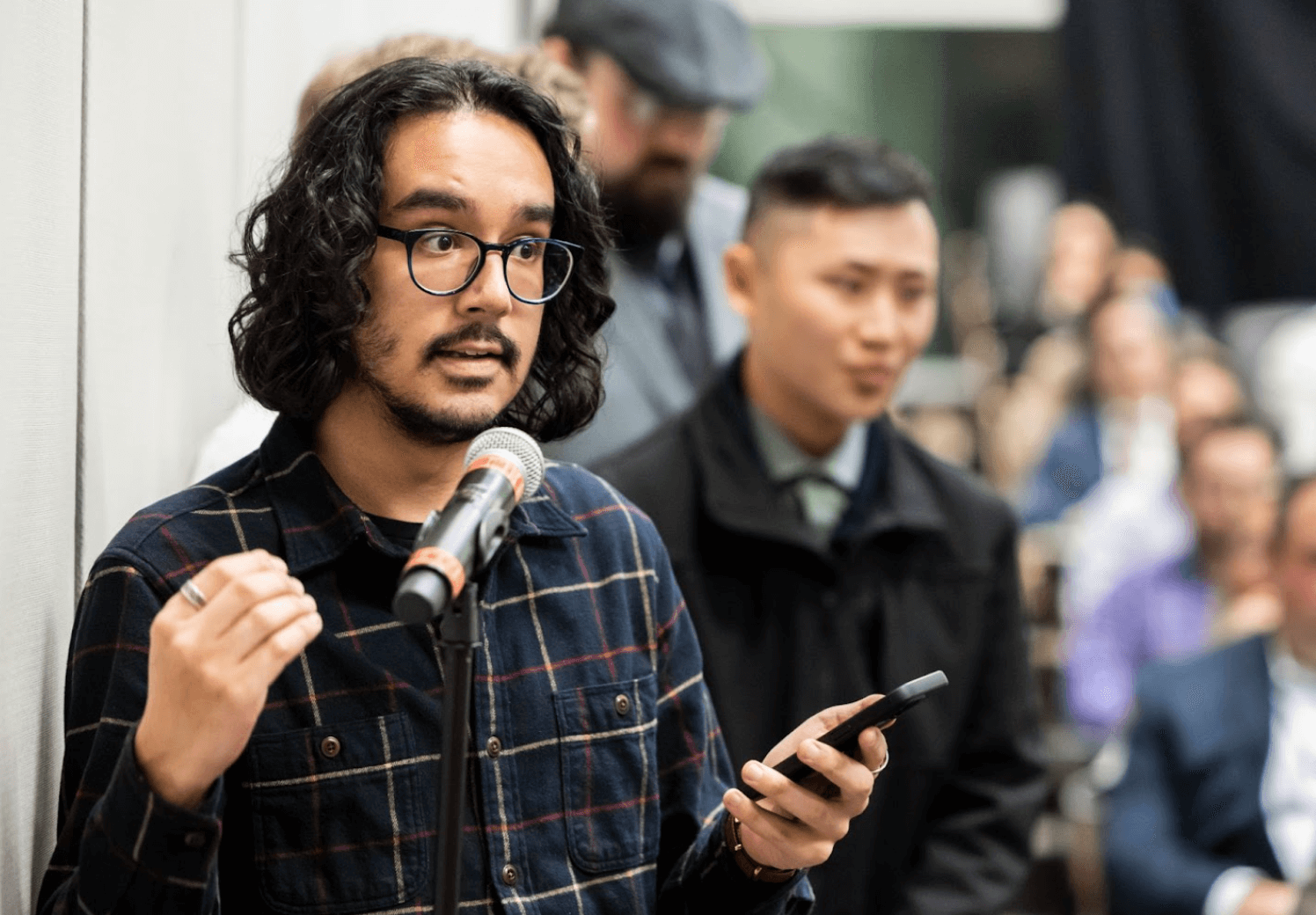 Man speaking with phone in his hand