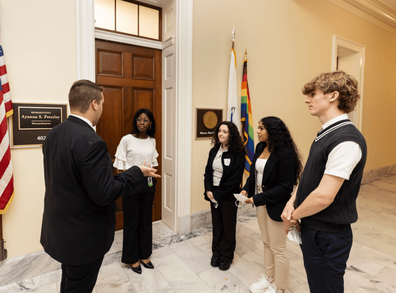 A group of people wearing business casual in a political building