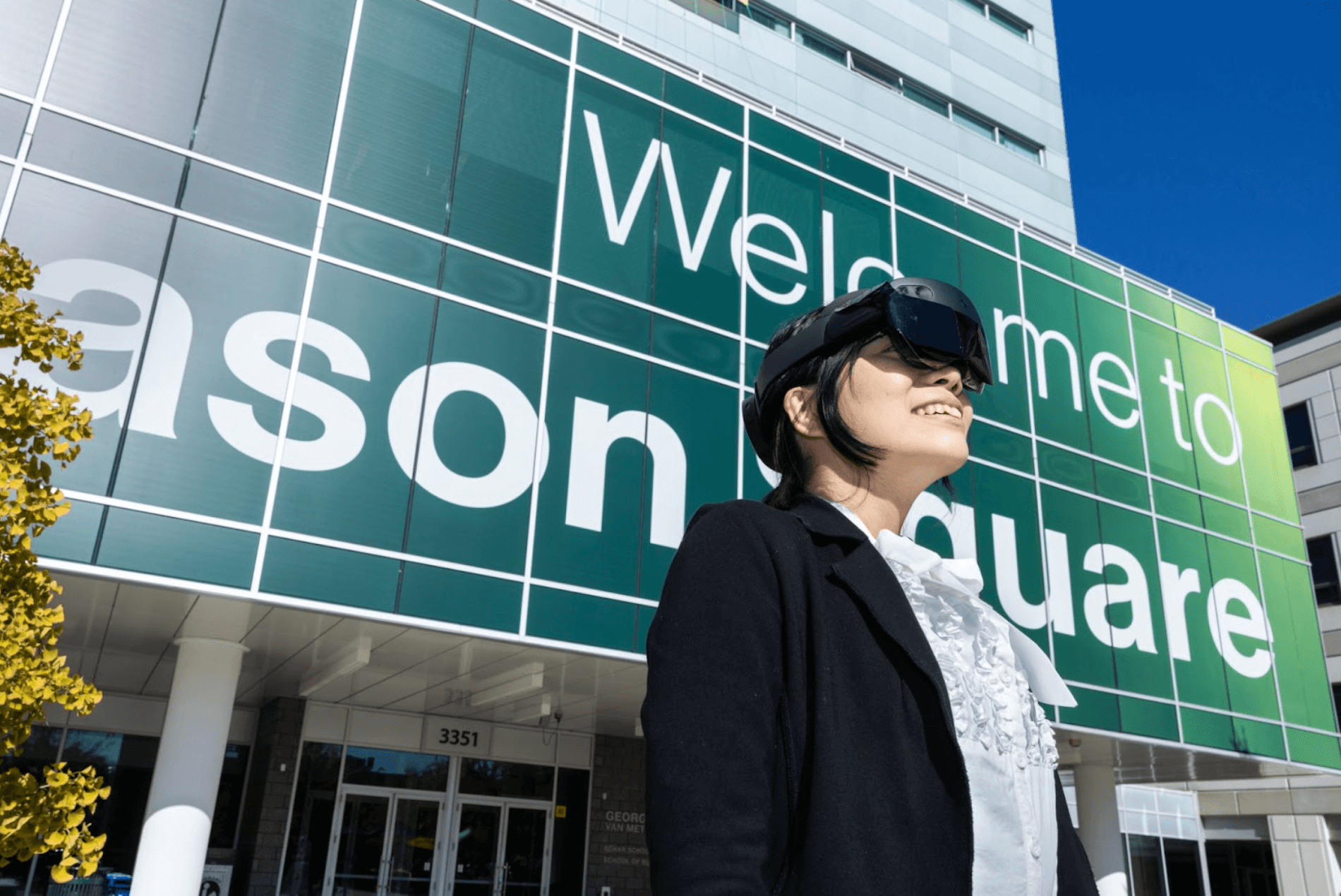 Woman wearing VR goggles outside the Mason Square building