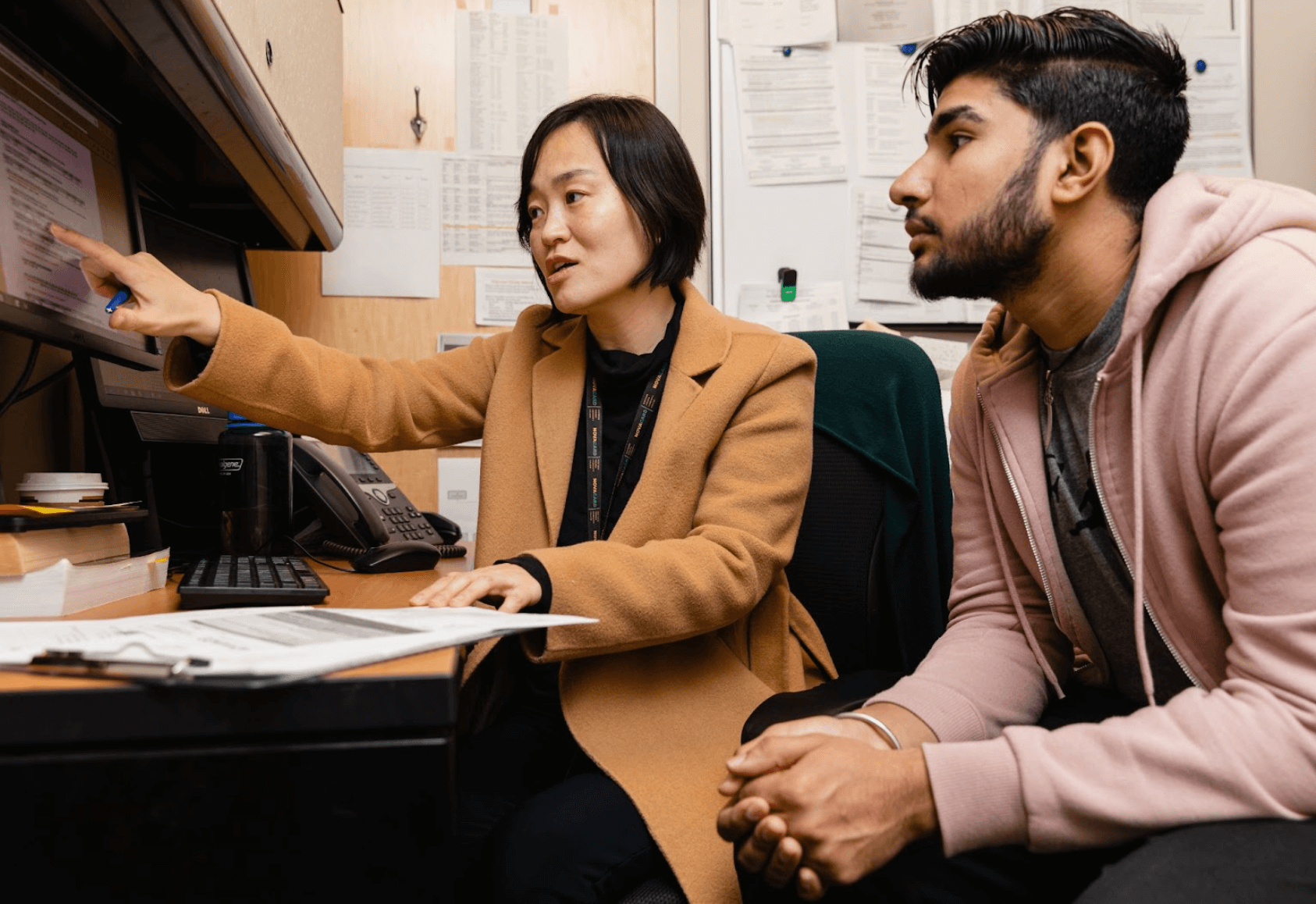Student working with professor at a compuer