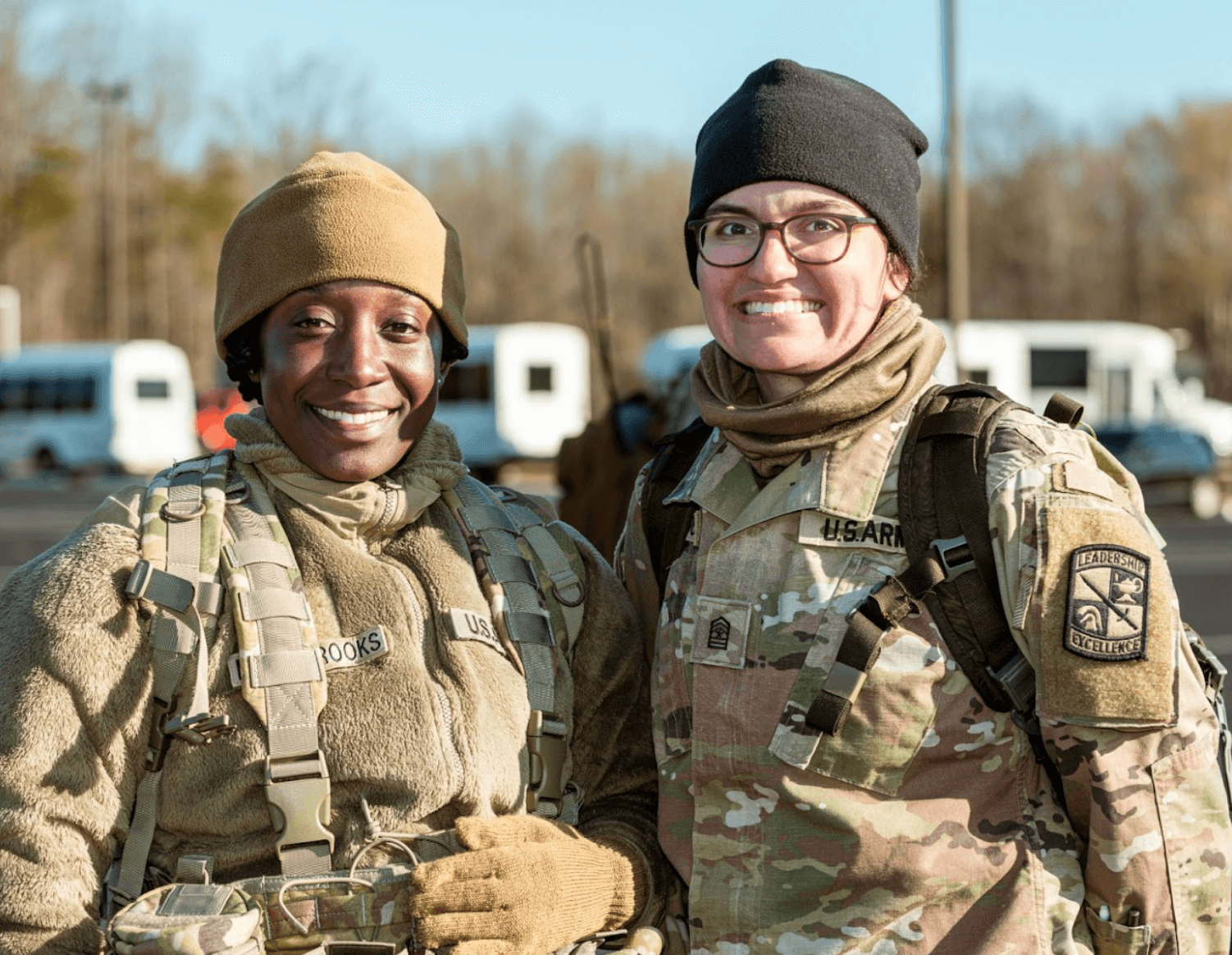 Two smiling women wearing their military uniforms