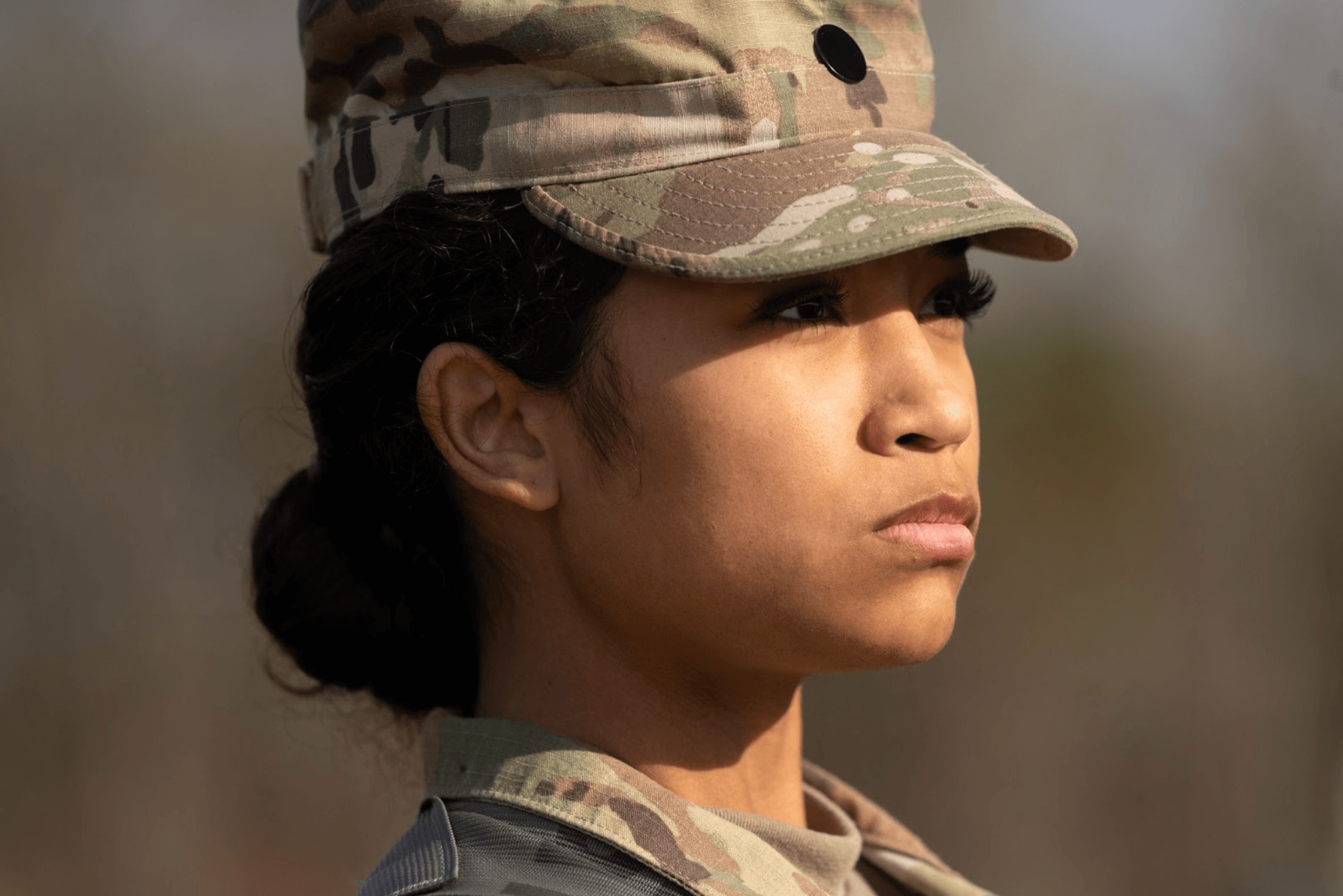 Close up of a serious woman in her military uniform with hat