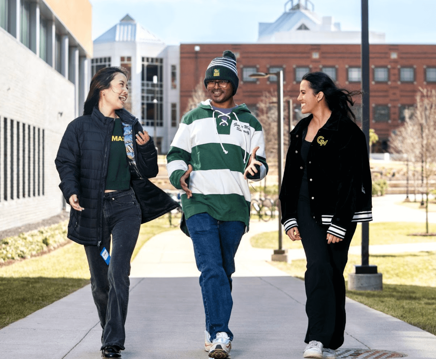 Three students walking together outside during winter