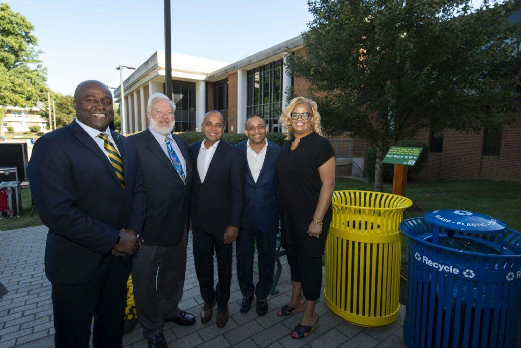 President Gregory Washington, Dean Ken Ball, Mahfuz Ahmed, Maruf Ahmed, and Trishana Bowden stand side by side outside the Fenwick Library on the Fairfax campus.