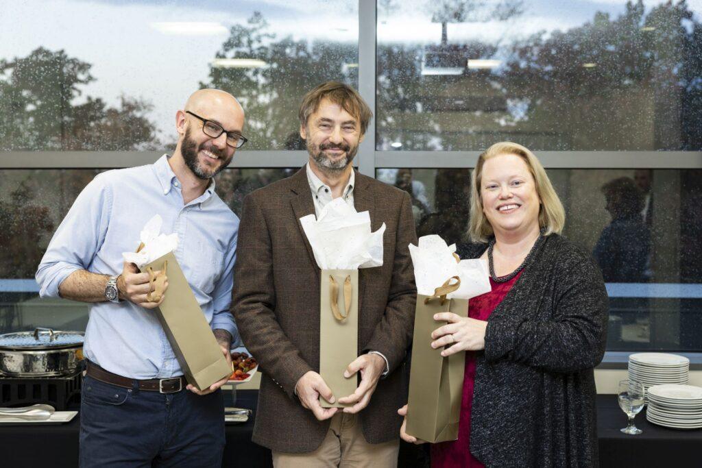 Katherine Scafide, David Lattanzi, and Janusz Wojtusiak pose with their gifts.