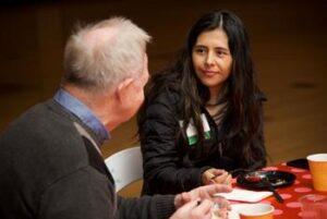 Two faculty and staff together at the Faculty and Staff Donor Breakfast event on the Fairfax Campus.