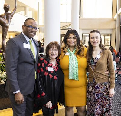 A group of 4 attendees pose at the University Scholarship Breakfast at Mason's Center for the Arts.