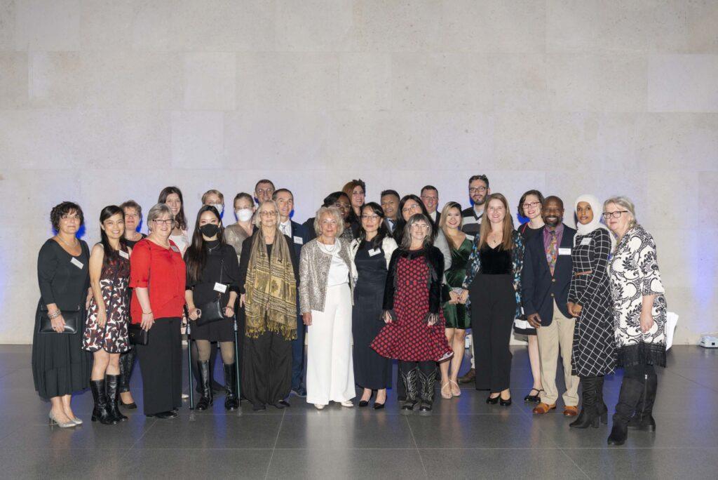 Diane Portnoy stands with a large group of attendees of The ILC's 30th anniversary gala.