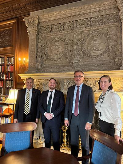 Dean Özerdem stands with John Hewko, CEO of Rotary International, Sarah Crawford, Director of Programs and Grants at Rotary International, and Dr. Charles Davidson of the Carter School.