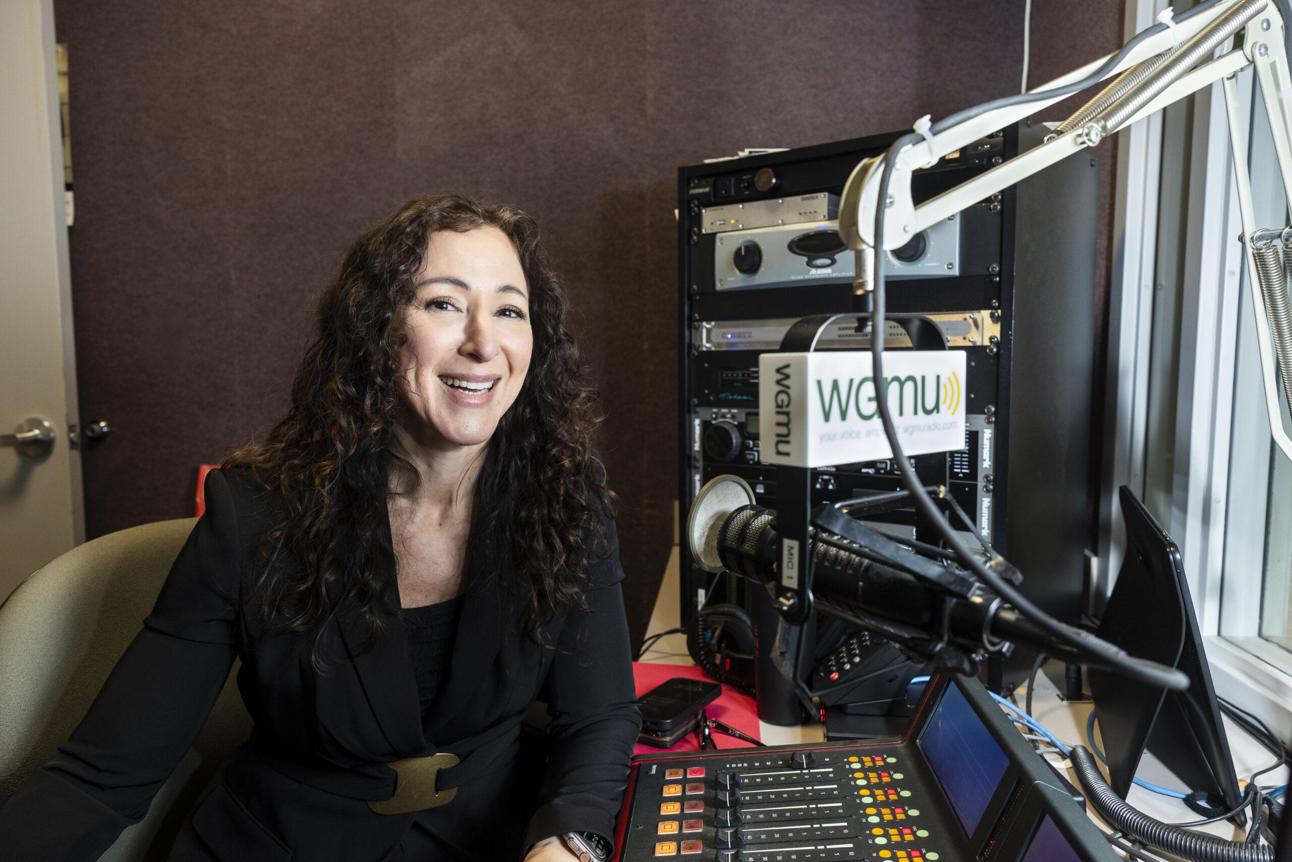 Dean Ingrid Guerra-Lopez sitting in a podcast studio.
