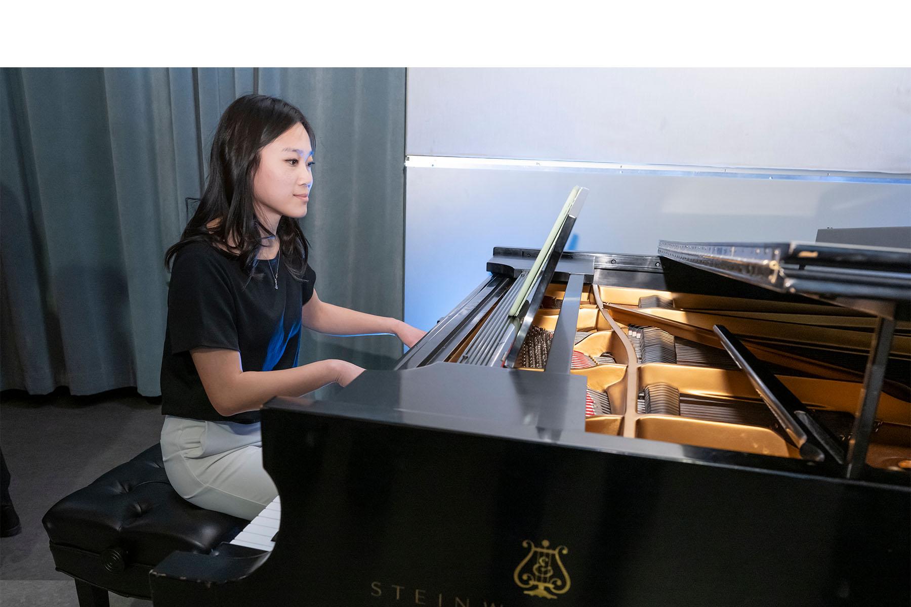 Event pianist seated at a piano.