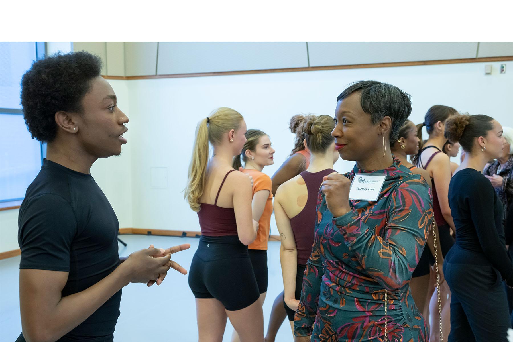 An event attendee speaking with a dancer.