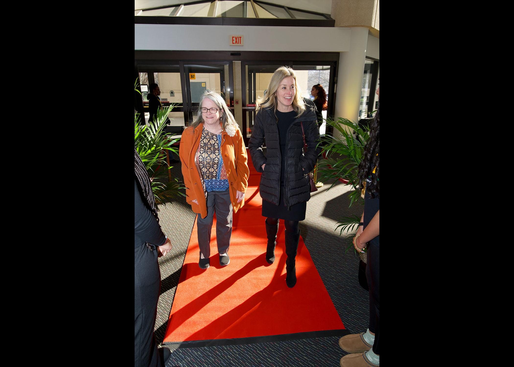 Two Attendees walk into Celebrating Our Champions event venue.