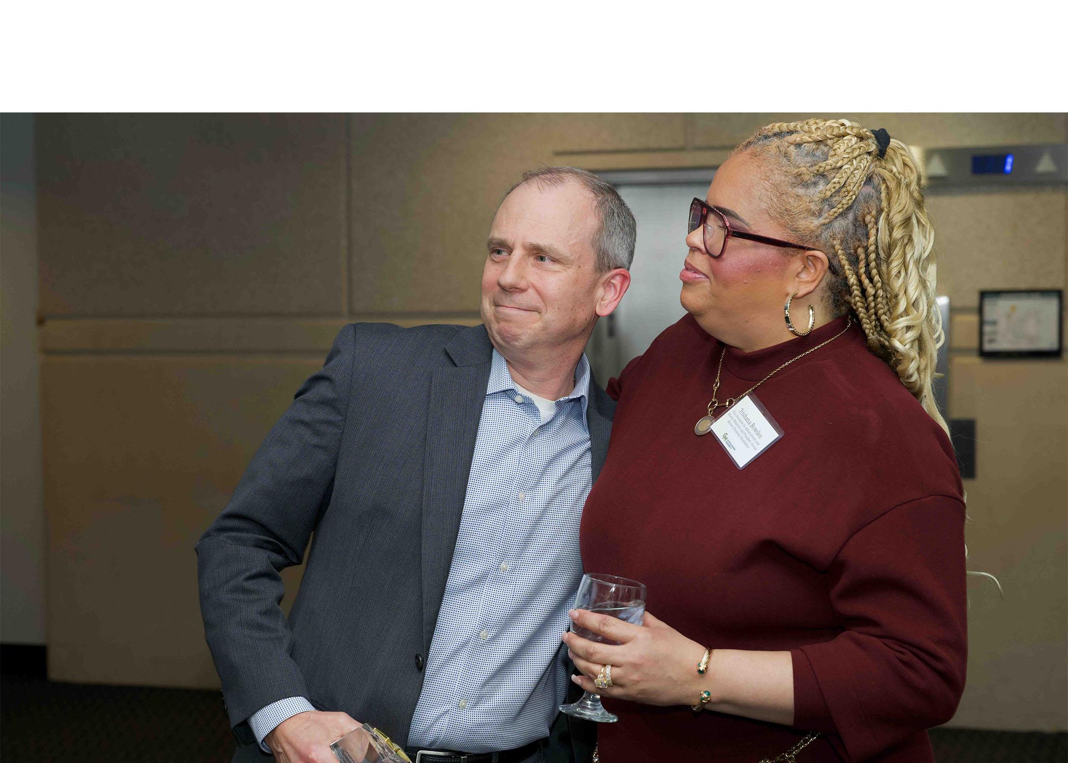 Keith Renshaw and Trishana Bowden stand together at Celebrating Our Champions event.