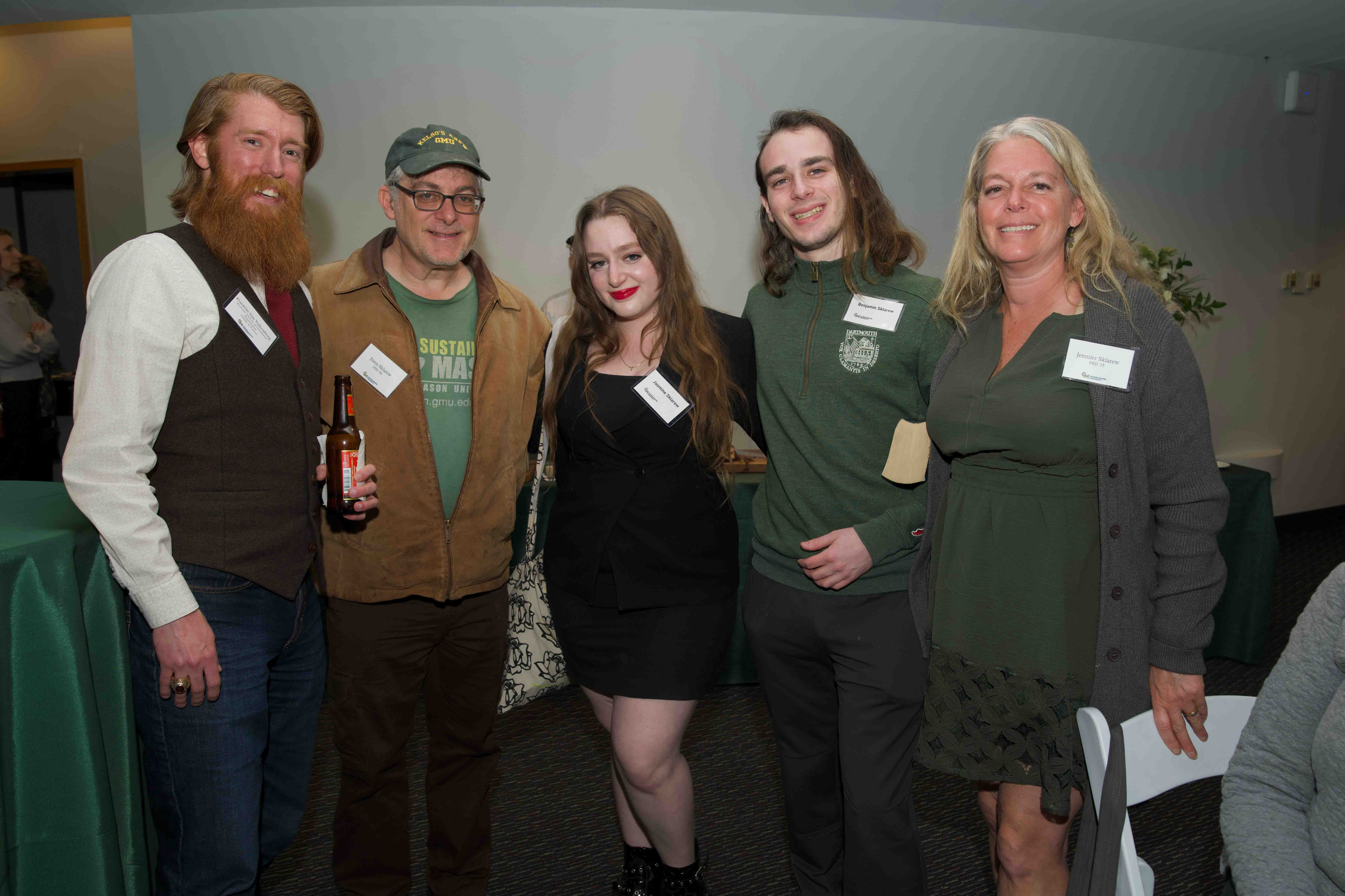 Five Celebrating Our Champions event attendees stand together.