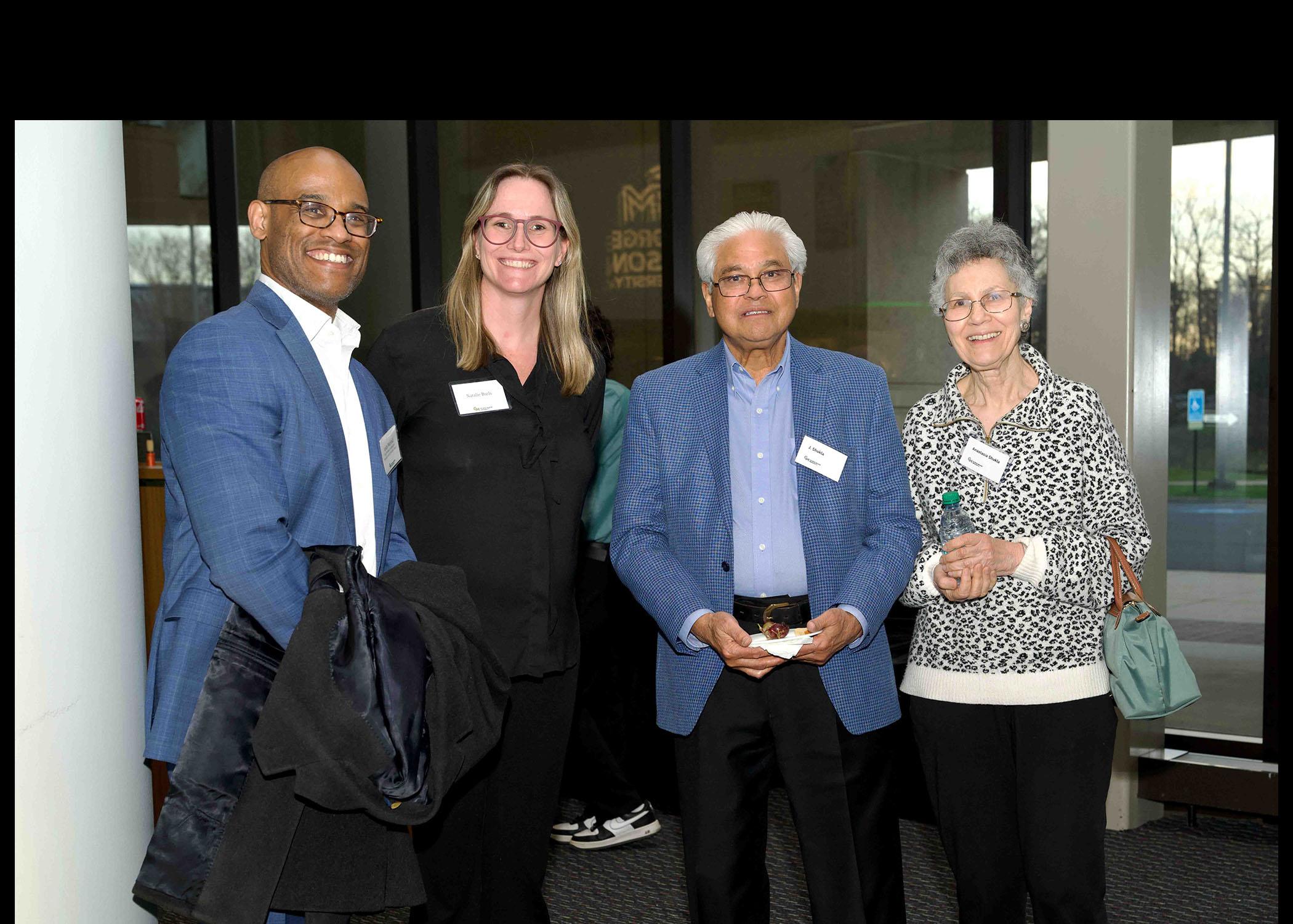 Four Celebrating Our Champions event attendees stand together.