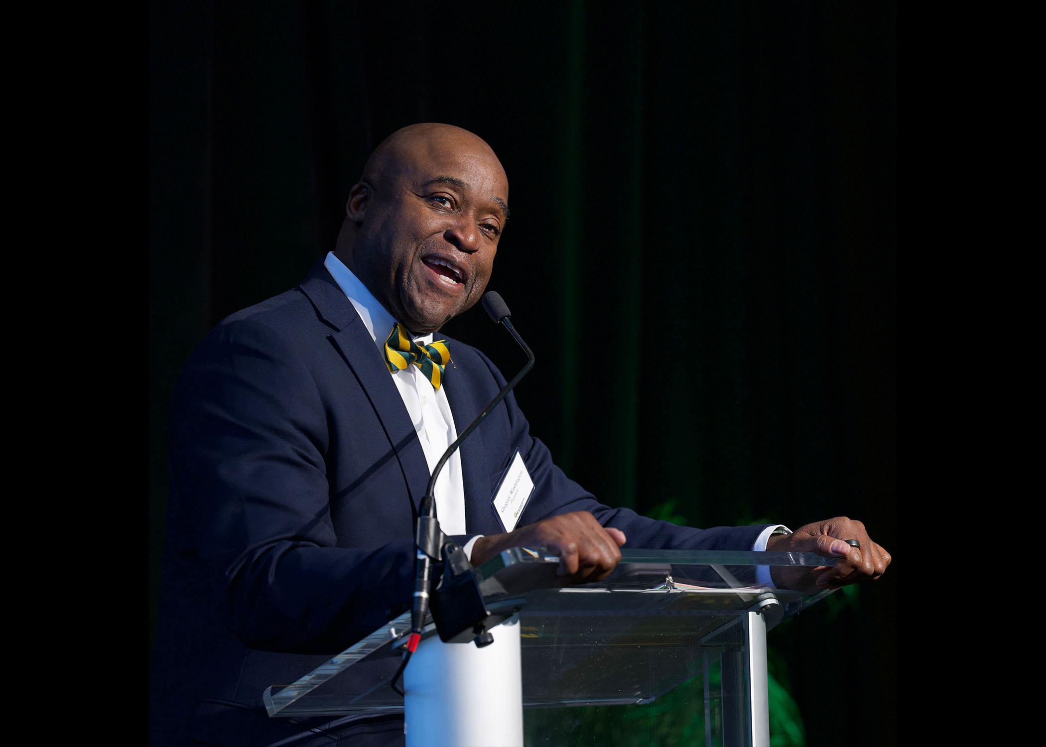 Dr. Washington stands at podium at Celebrating Our Champions event.