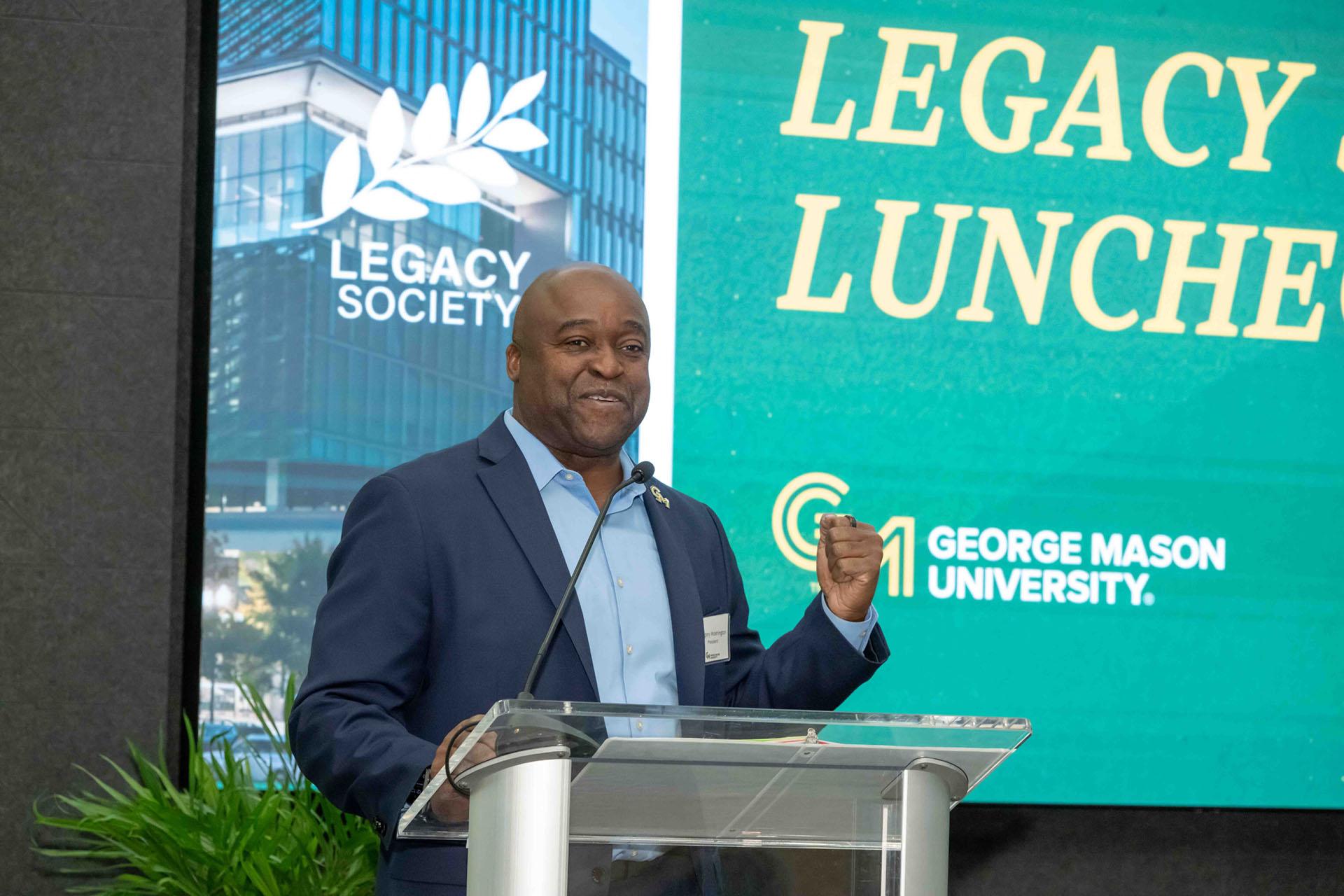 President Gregory Washington addresses attendees on stage at a podium.