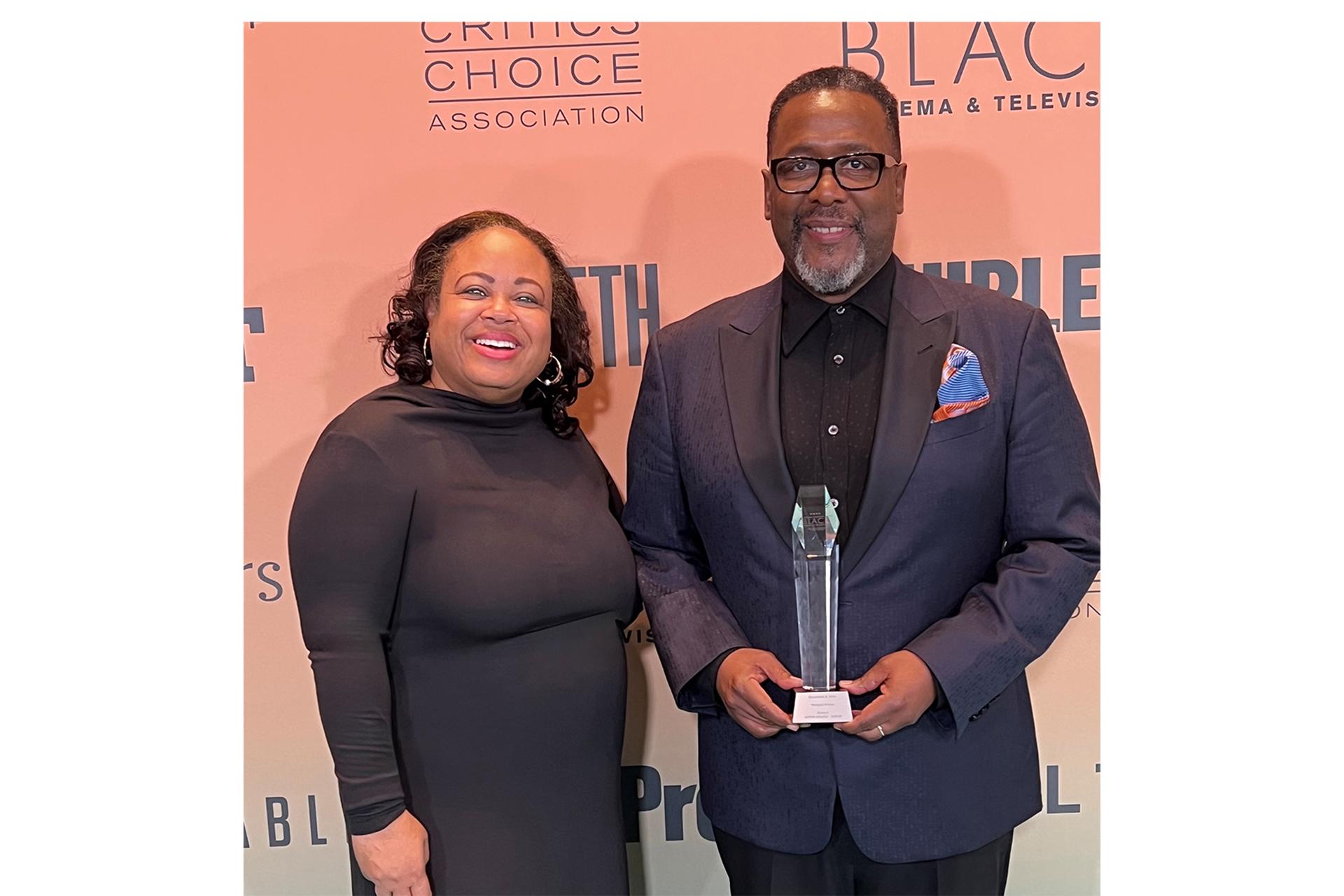 Gilda Squire and Wendell Pierce pose together, with Pierce holding an award.
