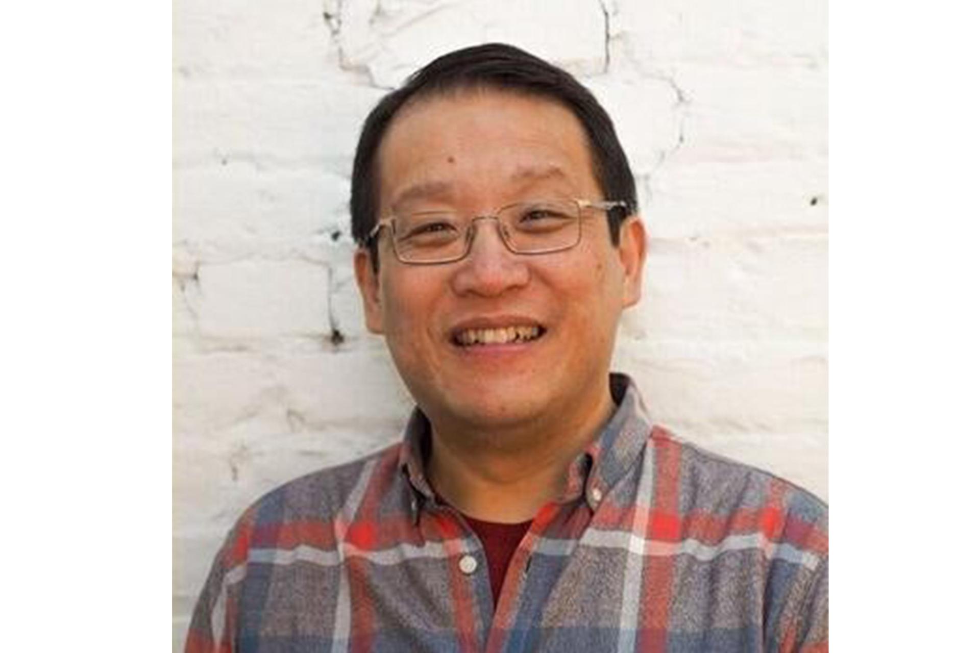 Paul So in front of a white background