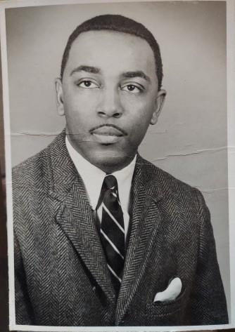 Spencer Chambliss Senior wearing a suit and tie.