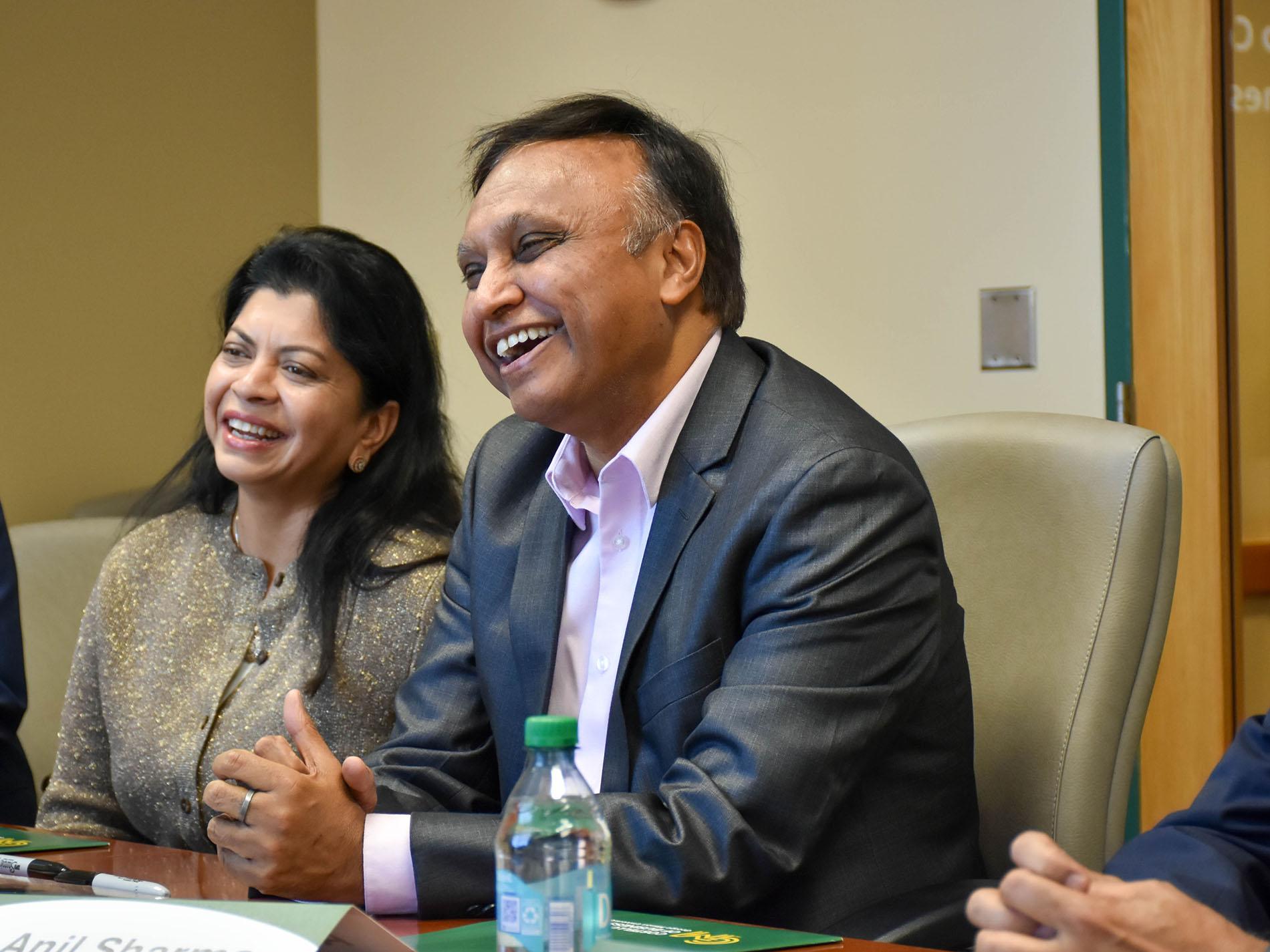 Anupama and Anil Sharma seated at a table